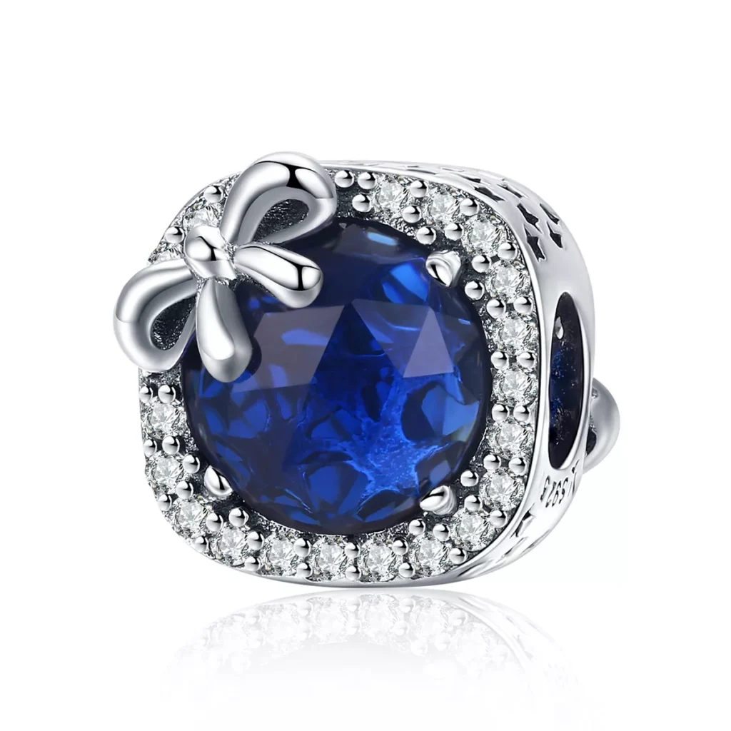Ασημένιο charm 925 με μπλε πέτρα σε σχήμα σταγόνας και λεπτομέρεια φιόγκου με ζιργκόν